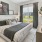 oversized windows brighten spacious bedroom