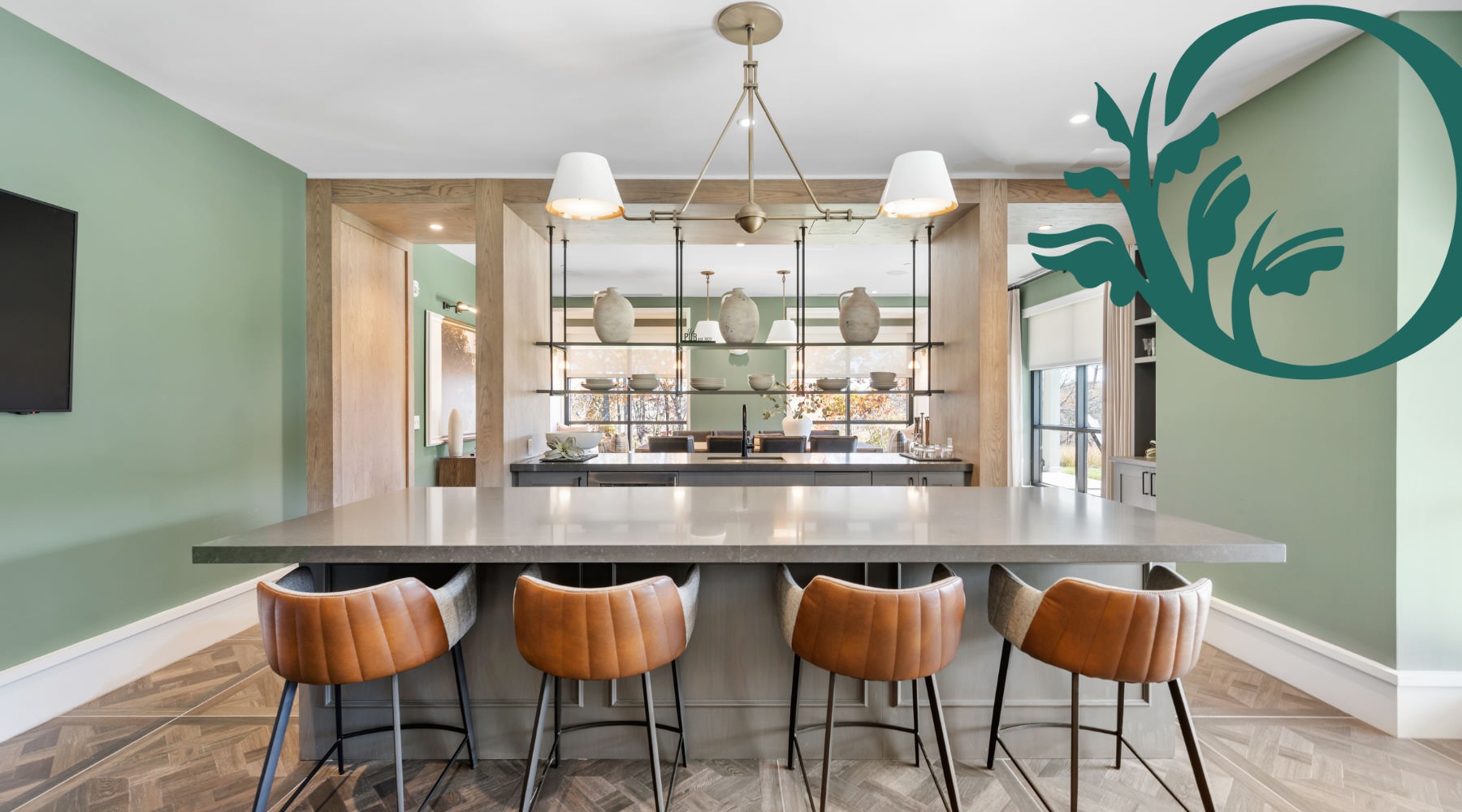 Where Luxury Meets Lifestyle Oxbow Wayland clubhouse kitchen with chairs at large island with a logo overlaying the photo